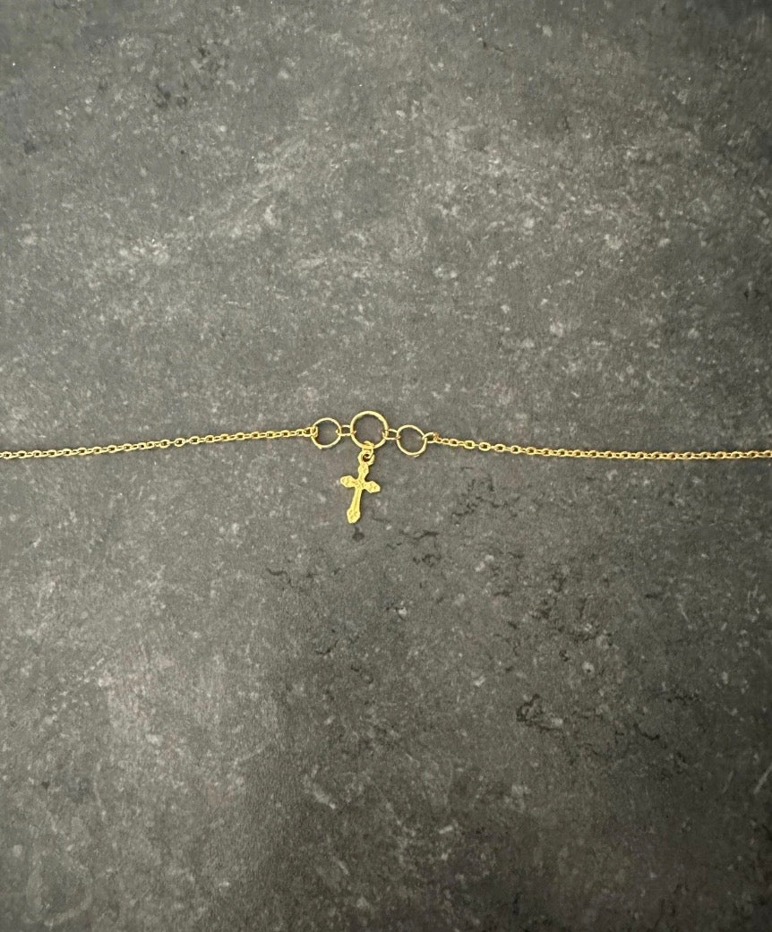 Icegold by Vee cross pendant belly chain featuring a delicate chain with a small cross pendant, perfect for accessorizing the waist.